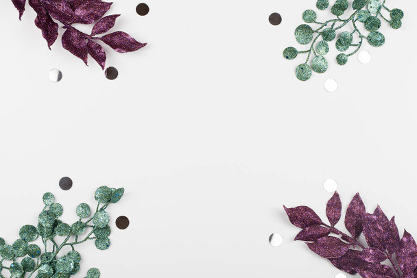 purple and green painted leaves on white background . Creative layout border frame. - Photo, Image