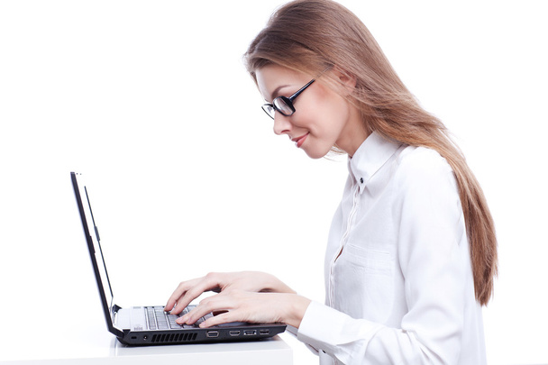 Young businesswoman, secretary or student working on laptop - Fotó, kép