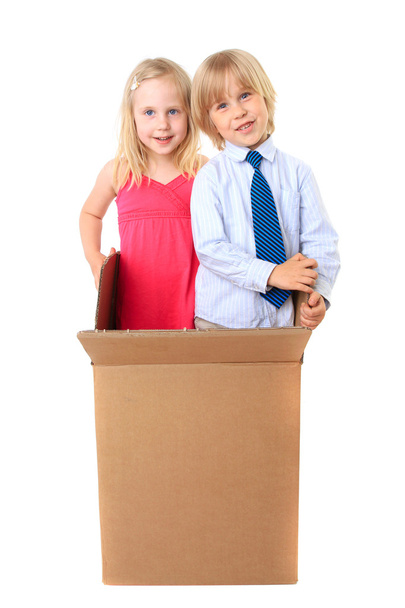 Joyful children look out from a cardboard box. Surprise. - Photo, image