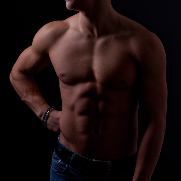 Perfect male body on black background. - Foto, afbeelding