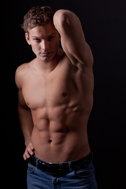 Muscle sexy naked young man posing in jeans - Foto, Imagen