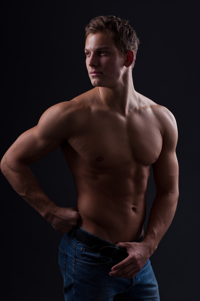 Muscle sexy naked young man posing in jeans - Foto, afbeelding