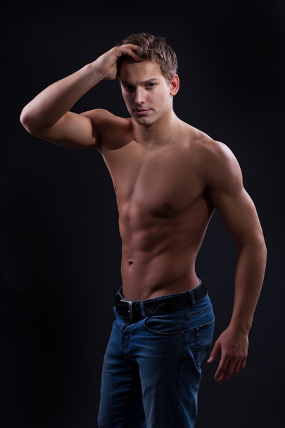 Muscle sexy naked young man posing in jeans - Foto, imagen