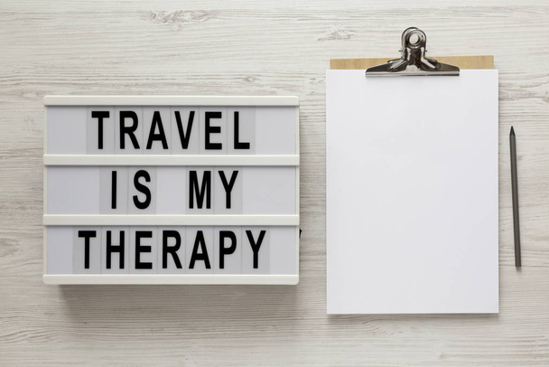 "Ταξίδι είναι η θεραπεία μου" λέξεις σε ένα lightbox, πρόχειρο με κενό - Φωτογραφία, εικόνα