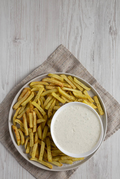 Homemade Crispy Ranch Fries on a gray plate on a white wooden su - Fotó, kép