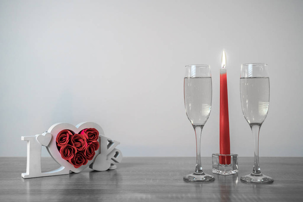 Wooden love frame, burning candles and champagne glasses - Foto, Imagem