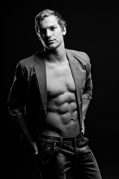 Black and white portrait of sexy man with open jacket over dark - Photo, image