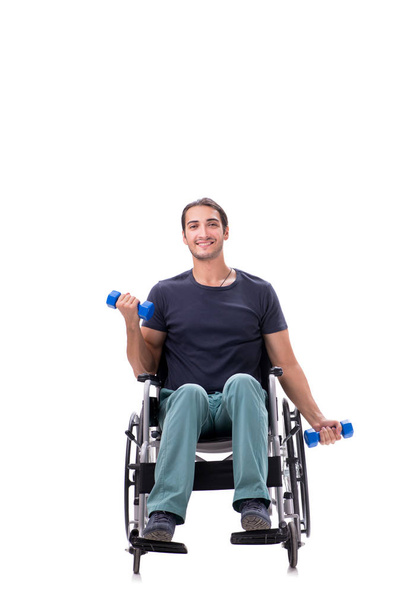 Mladý zdravotně postižený muž dělá fyzická cvičení izolované na bílém - Fotografie, Obrázek