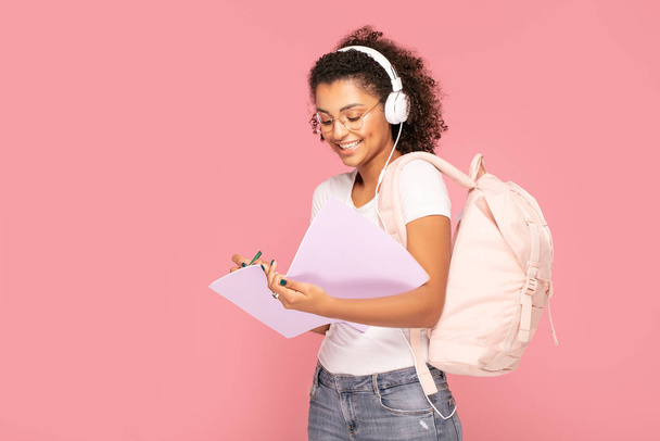 Happy student girl with backpack and notebooks. - Foto, imagen