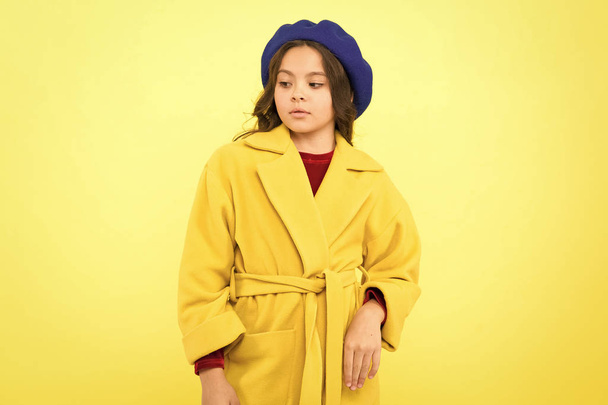 Everyone needs coat this winter. Girl fashionable cute model wear yellow wool coat. Pensive child in warm clothes. Personal styling and bespoke tailoring. Feeling cozy and comfortable in proper coat - 写真・画像