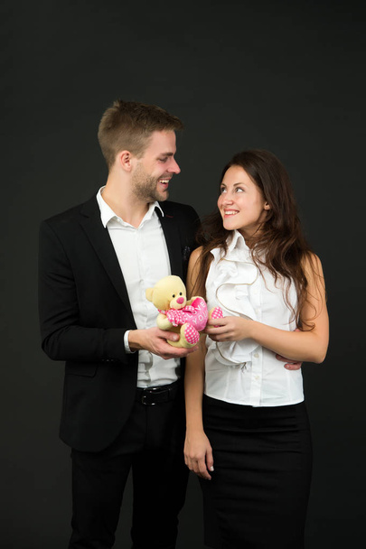 Flirting and dating. Love and romance. Gift with love. Couple on romantic date. Formal couple with toy. Man and woman corporate attire fashion. Couple in love celebrate valentines day. Surprise - Fotoğraf, Görsel