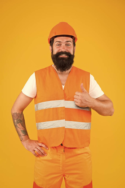 Good job. Safety apparel for construction industry. Bearded brutal hipster safety engineer. Man engineer protective uniform orange background. Engineering career concept. Architect builder engineer - 写真・画像