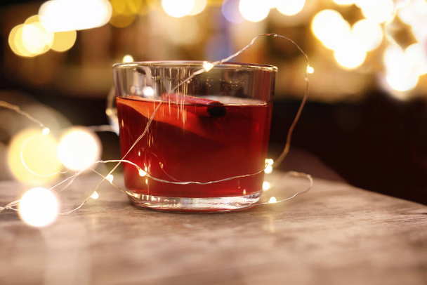 Tasty aromatic mulled wine on wooden table - Photo, image