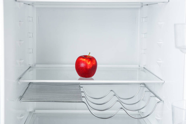 Fresh red apple on empty shelf in refrigerator - Valokuva, kuva