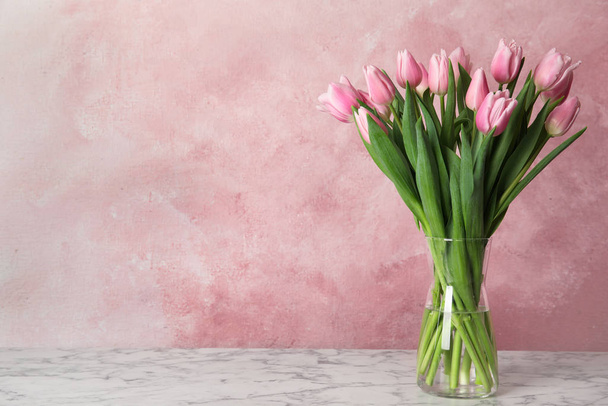 Beautiful pink spring tulips on marble table. Space for text - Foto, immagini