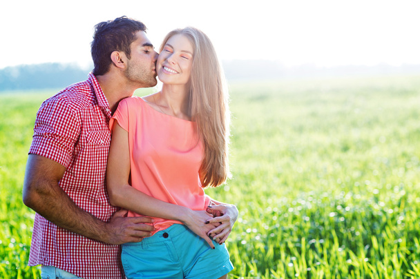 Romantic young couple in a field - Фото, изображение