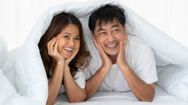 asian mature couple happy with romantic moment together under bl - Фото, изображение