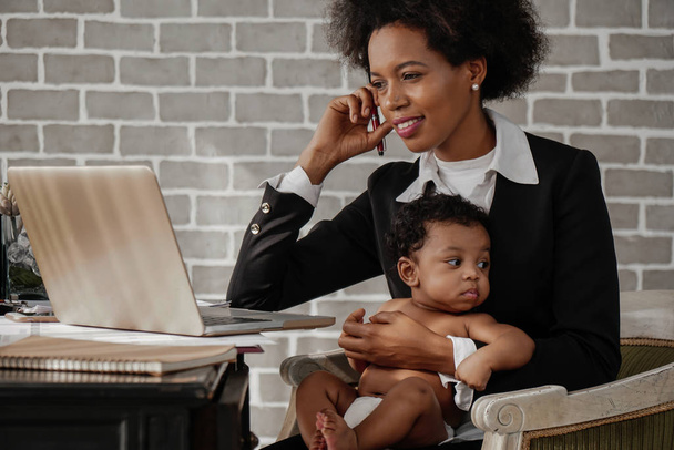 african american business woman taking care of her baby boy whil - Photo, image