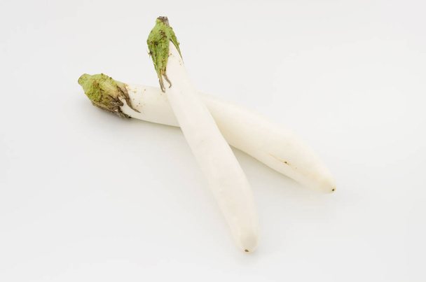 Long white eggplant on white background - Фото, изображение