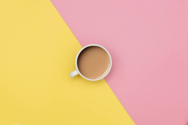 Caffè con latte su fondo giallo e rosa. Vista sopra
 - Foto, immagini