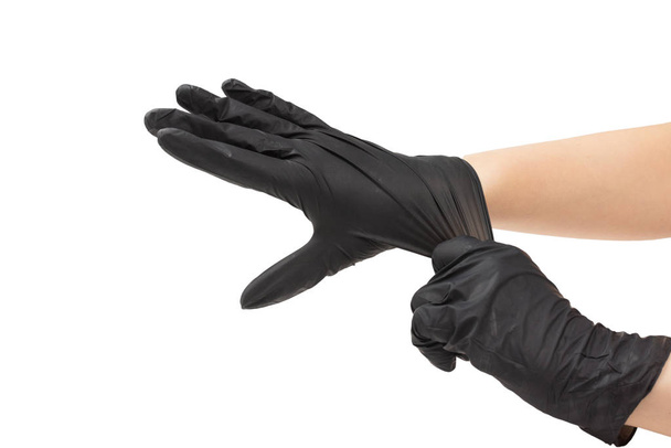 Η γυναίκα φοράει μαύρα λαστιχένια γάντια.  - Φωτογραφία, εικόνα