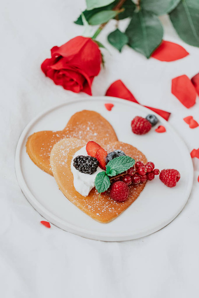 Valentine's Day heart shapes pancake with berries.. morning breakfast with coffee and pancakes - Φωτογραφία, εικόνα
