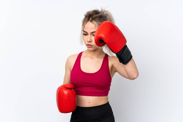 Teenager girl holding waffles over isolated blue background with boxing gloves - Photo, Image