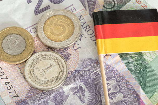close-up πολωνικών ζλότυ τραπεζογραμματίων και κερμάτων με γερμανική σημαία - Φωτογραφία, εικόνα