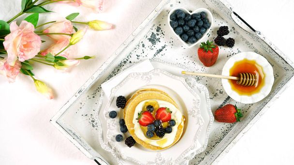 Pancake breakfast tray on table with syrup and blueberries fruit flat lay. - Photo, Image