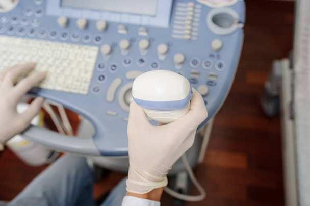 The doctor using the ultrasonography device - Photo, Image