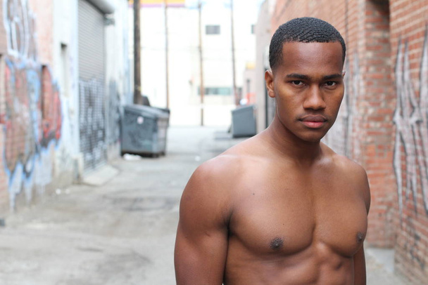 close-up portrait of handsome shirtless African american young man on street - Фото, зображення