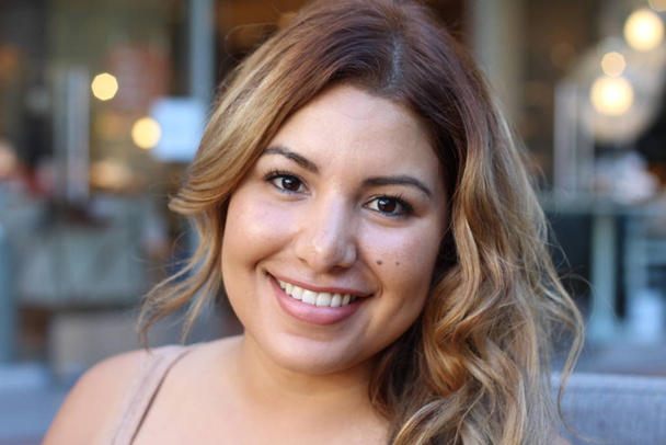 Portrait of a young Hispanic female smiling  - Фото, изображение