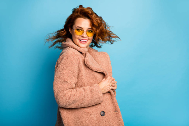 Turned photo of candid cute pretty sweet woman enjoy free time holiday wear outerwear season coat outfit isolated over blue color background - Photo, Image