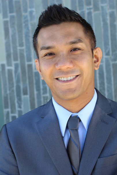 close-up portrait of handsome young businessman in grey suit of mixed race - Photo, Image