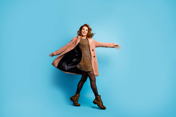 Full body photo of candid lovely funky pretty woman hold hands go walk enjoy free time wear look tights boots isolated over blue color background - 写真・画像