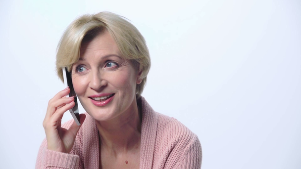 mujer madura hablando en teléfono inteligente aislado en blanco
  - Metraje, vídeo