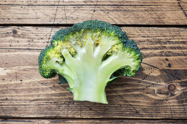 Fresh head of broccoli on a wooden table. Copy space. - Photo, image