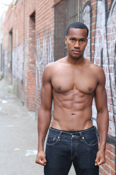close-up portrait of handsome shirtless African american young man on street - Fotó, kép