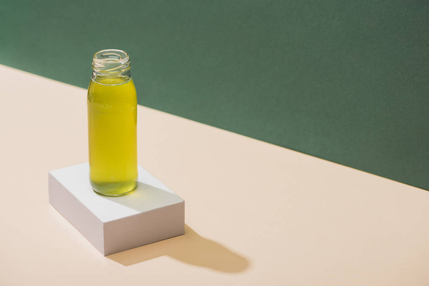 kiwi fresh juice on white cube on green and white background - Photo, Image