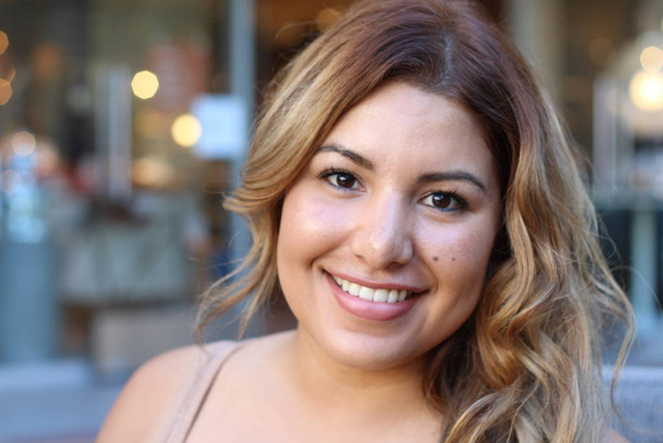 Portrait of a young Hispanic female smiling  - Фото, изображение