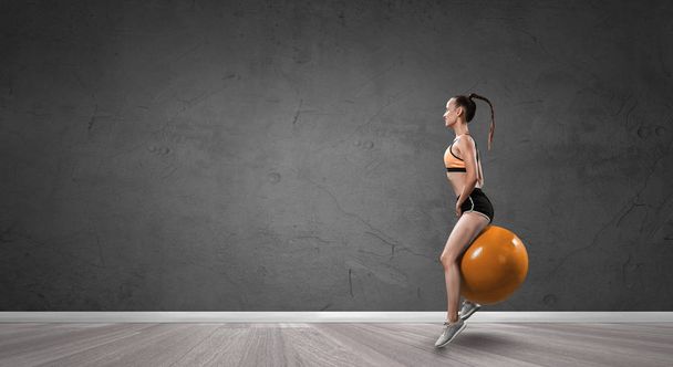 Sporty woman on fitness ball. Mixed media - Fotoğraf, Görsel