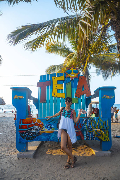 Tela, Honduras - January 2020: woman posing at Tela sign on tropical beach  - Valokuva, kuva
