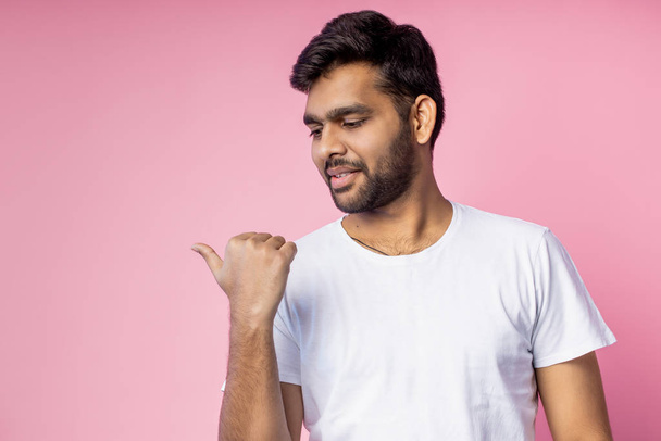 Portrait of handsome Indian guy standing on pink background - Фото, зображення