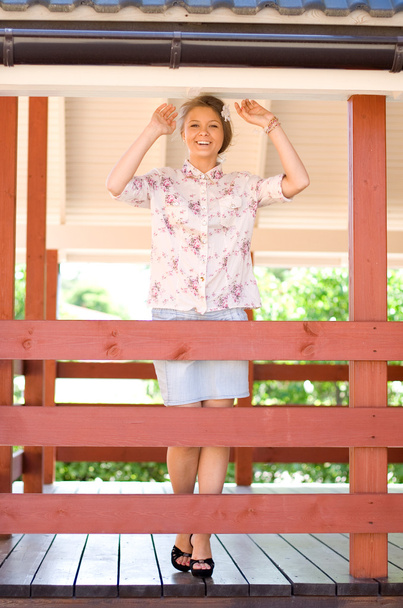 Girl standing on a veranda - Photo, image
