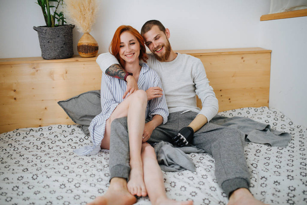 Happy married couple chilling on a double bed at home - Fotoğraf, Görsel