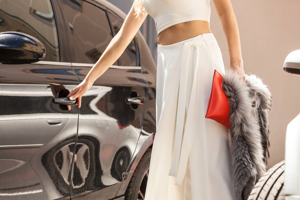 Fashionable woman opening car - Foto, Imagen