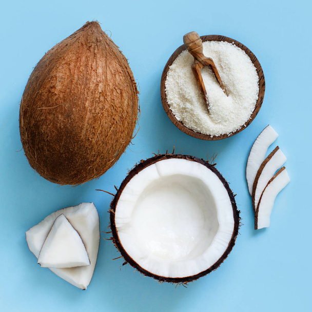 Coconut flour in a bowl with coconut pieces top view - Foto, Bild