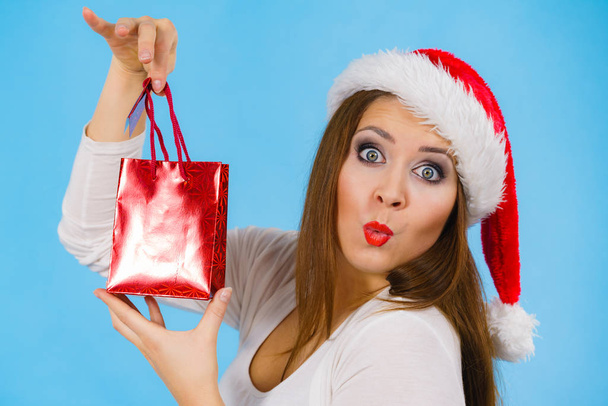 Happy Christmas woman holds gift bag - Фото, изображение