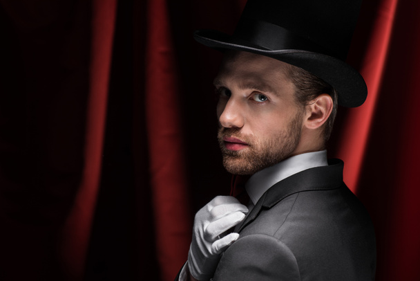 handsome gentleman in circus with red curtains - Foto, imagen