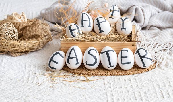 Easter eggs with the inscription happy Easter, holiday decor . - 写真・画像